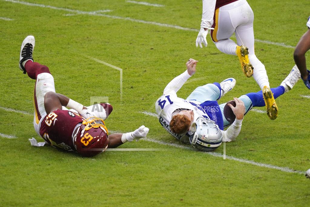 Patrick Semansky Dallas Cowboys quarterback Andy Dalton's (14) helmet comes off after getting hit by Washington Football Team inside linebacker Jon Bostic (53) in the second half of an NFL football game, Sunday, Oct. 25, 2020, in Landover, Md. Dalton left the field after this hit and Bostic was ejected from the game. (AP Photo/Patrick Semansky)