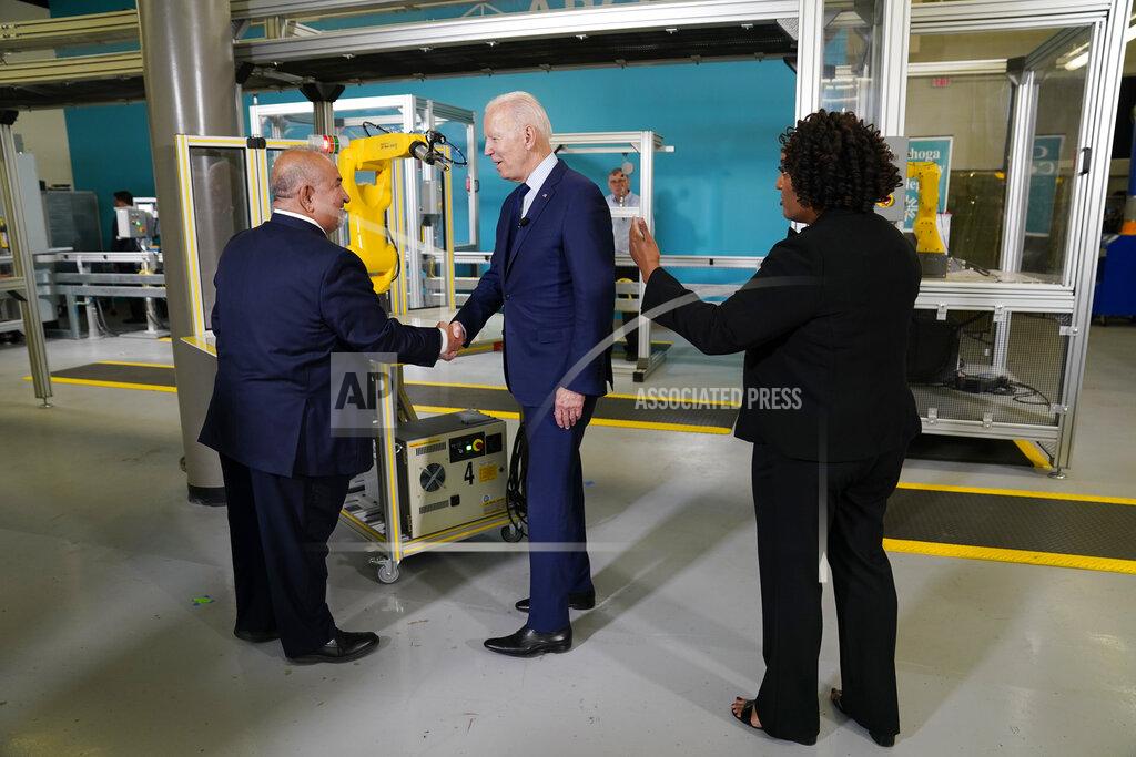 Evan Vucci President Joe Biden shakes a persons hand as he tours the Cuyahoga Community College Manufacturing Technology Center, Thursday, May 27, 2021, in Cleveland. (AP Photo/Evan Vucci)