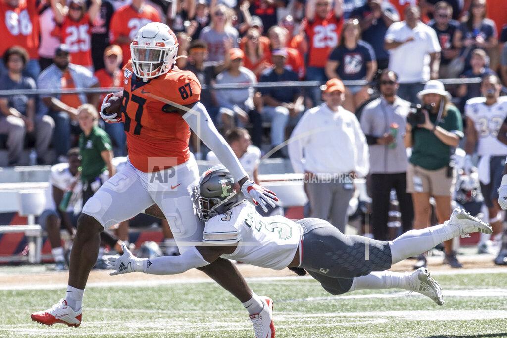 Holly Hart Illinois tight end Daniel Barker (87) runs the ball after making a catch as Eastern Michigan's Vince Calhoun (3) attempts the tackle n the first half of a NCAA college football game between Illinois and Eastern Michigan, Saturday, Sept.14, 2019, in Champaign, Ill. (AP Photo/Holly Hart)