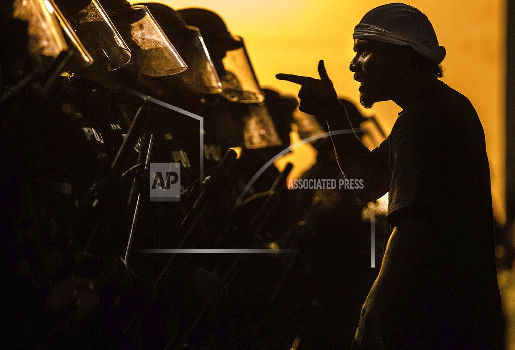 Josh Galemore FILE - In this May 30, 2020 file photo, a protester addresses a line of Tucson Police Officers in riot gear in Tucson, Ariz. Hundreds of officers across the country were fired, sometimes repeatedly, for violating policies but got their jobs back after appealing their cases to an arbitrator who successfully overturned their discipline – a all-too-common practice that experts say stands in the way of real accountability. On Monday, June 22, 2020 James Pasco, executive director of the National Fraternal Order of Police, said " management should do a better job when hiring officers. (Josh Galemore/Arizona Daily Star via AP)