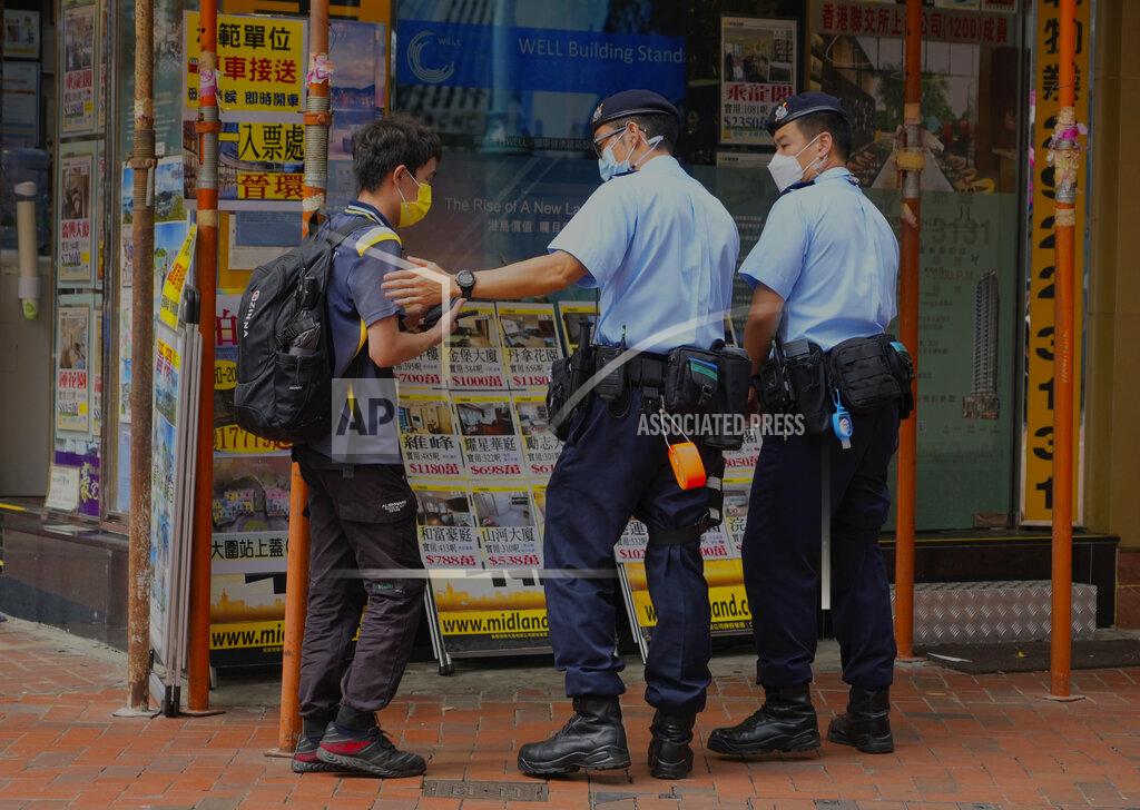 Vincent Yu Police officers check a young man outside Hong Kong Victoria Park, Friday, June 4, 2021. Police arrested an organizer of Hong Kong's annual candlelight vigil remembering the deadly Tiananmen Square crackdown and warned people not to attend the banned event Friday as authorities mute China's last pro-democracy voices. In past years, tens of thousands of people gathered in Hong Kong's Victoria Park to honor the victims who died when China’s military put down student-led pro-democracy protests on June 4, 1989, killing hundreds if not thousands. (AP Photo/Vincent Yu)