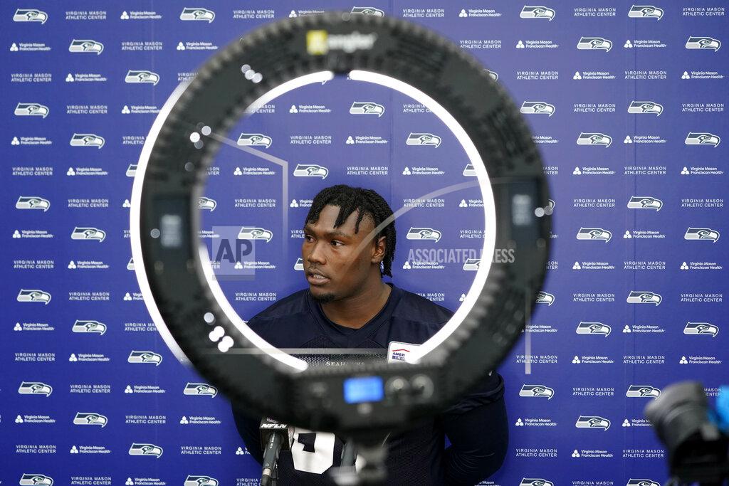 Ted S. Warren Seattle Seahawks offensive tackle Charles Cross takes questions from reporters in front of a circular video light following NFL football rookie minicamp Friday, May 6, 2022, in Renton, Wash. (AP Photo/Ted S. Warren)