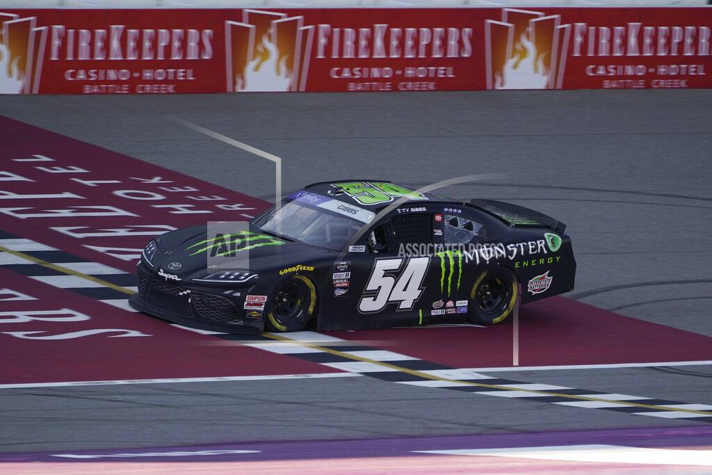 Paul Sancya Ty Gibbs crosses the finish line to win the New Holland 250 NASCAR Xfinity Series auto race at the Michigan International Speedway in Brooklyn, Mich., Saturday, Aug. 6, 2022. (AP Photo/Paul Sancya)