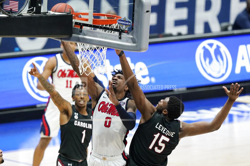 Mark Humphrey Mississippi's Romello White (0) scores against South Carolina's T.J. Moss (1) and Wildens Leveque (15) in the first half of an NCAA college basketball game in the Southeastern Conference Tournament Thursday, March 11, 2021, in Nashville, Tenn. (AP Photo/Mark Humphrey)