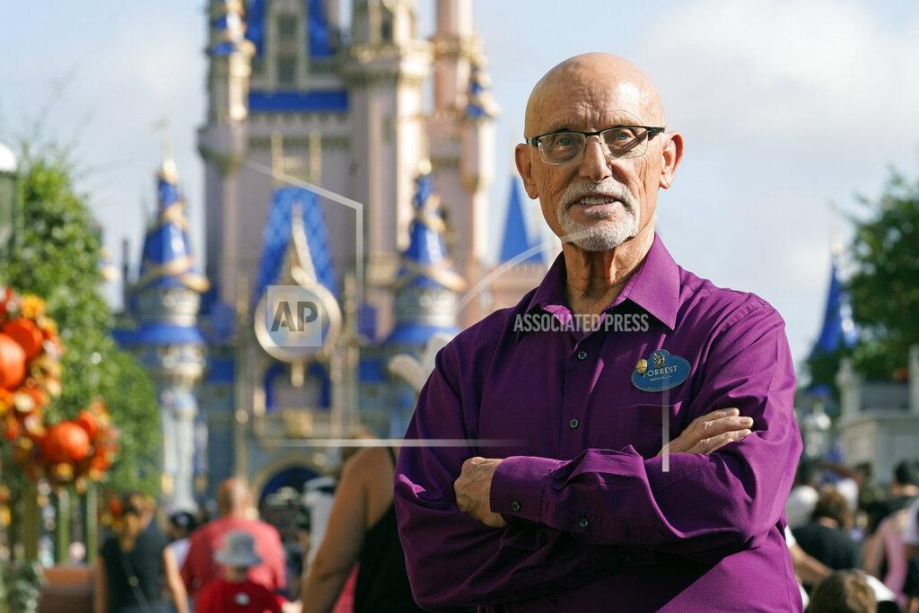 John Raoux Forrest Bahruth stands on Main Street in front of the Cinderella Castle at the Magic Kingdom theme park at Walt Disney World Monday, Aug. 30, 2021, in Lake Buena Vista, Fla. Bahruth has been working at Disney since the opening day in 1971. (AP Photo/John Raoux)