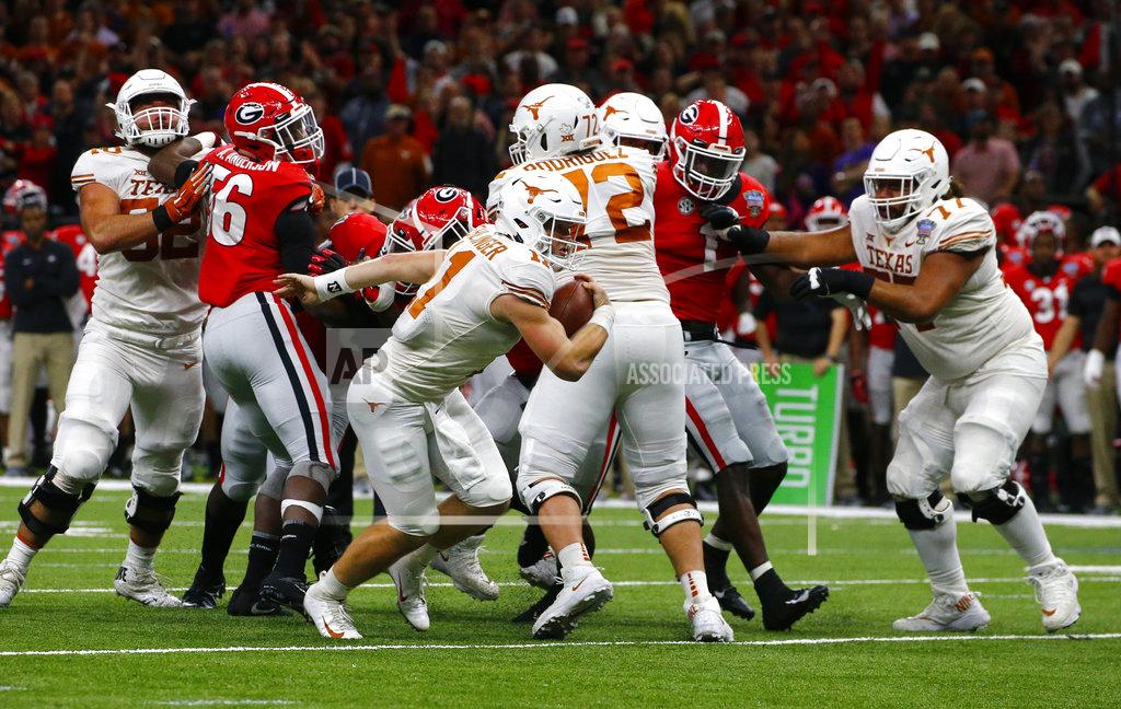 Butch Dill Texas quarterback Sam Ehlinger (11) breaks loose on a touchdown carry during the first half of the Sugar Bowl NCAA college football game against Georgia in New Orleans, Tuesday, Jan. 1, 2019. (AP Photo/Butch Dill)