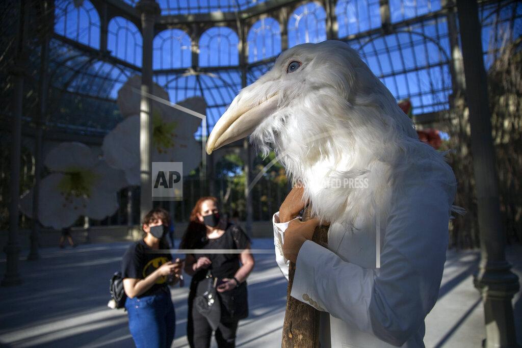 Andrea Comas People look at an artwork called "History of a Hug" by visual artist Petrit Halilaj inside the Cristal palace in the Retiro park in Madrid, Spain, Friday, Aug. 28, 2020. Authorities in Madrid, the hottest spot in Spain's new surge of coronavirus contagion, said Thursday they would close parks at night to prevent COVID-19. (AP Photo/Andrea Comas)