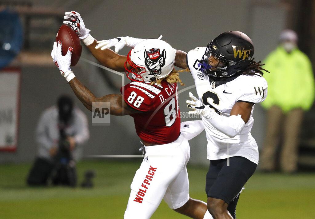 Ethan Hyman North Carolina State wide receiver Devin Carter (88) pulls in a 2-yard touchdown reception as Wake Forest defensive back Ja'Sir Taylor (6) tries to tip the ball away during the second half of an NCAA college football game in Raleigh, N.C, Saturday, Sept. 19, 2020. (Ethan Hyman/The News & Observer via AP)