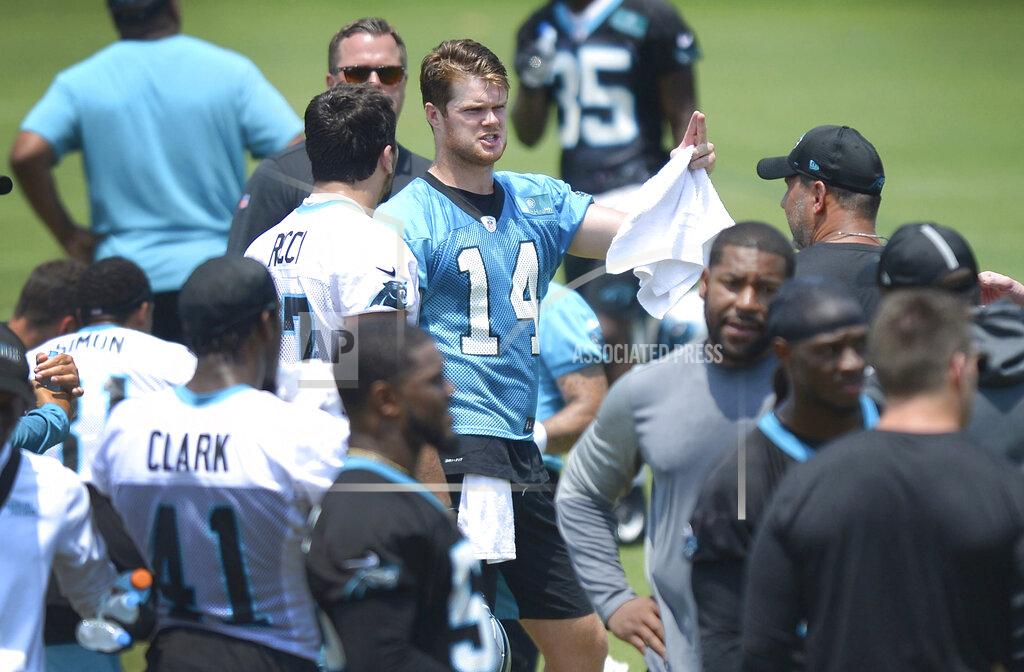 Jeff Siner Carolina Panthers quarterback Sam Darnold, center, speaks with a teammate during a break in drills at the team's OTA football practice on Tuesday, May 25, 2021 in Charlotte, N.C. (Jeff SIner/The Charlotte Observer via AP)