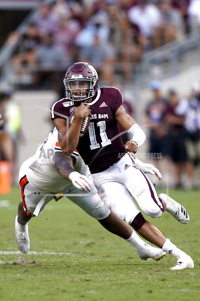 Sam Craft Texas A&M quarterback Kellen Mond (11) runs away from an Auburn defender during the second half of an NCAA college football game, Saturday, Sept. 21, 2019, in College Station, Texas. (AP Photo/Sam Craft)
