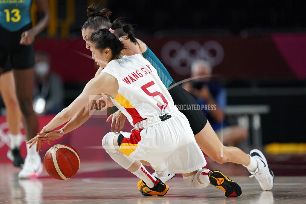 Eric Gay China's Siyu Wang (5) and Australia's Katie Ebzery battle for the ball during a women's basketball preliminary round game at the 2020 Summer Olympics in Saitama, Japan, Friday, July 30, 2021. (AP Photo/Eric Gay)