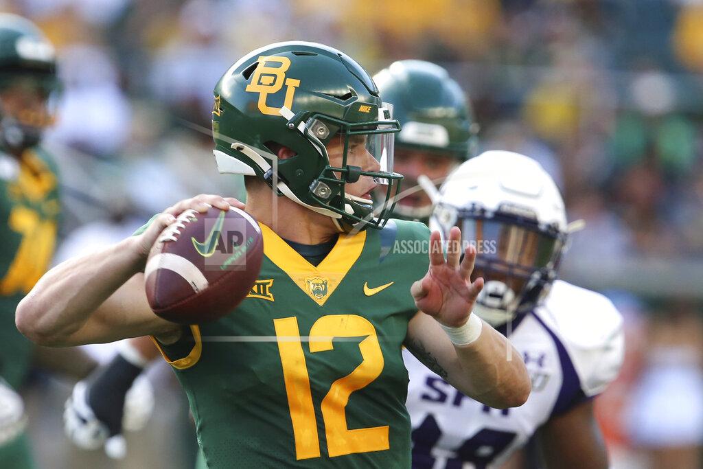 FILE - In this Aug. 31, 2019, file photo, Baylor quarterback Charlie Brewer throws downfield against Stephen F. Austin in the first half of an NCAA college football game, in Waco, Texas. Charlie Brewer is finally entrenched as Baylor’s quarterback in his third season starting games. Frank Harris, also a touted dual-threat recruit as a Texas high school senior three years ago, is just getting started at UTSA. (Rod Aydelotte/Waco Tribune-Herald via AP, File)