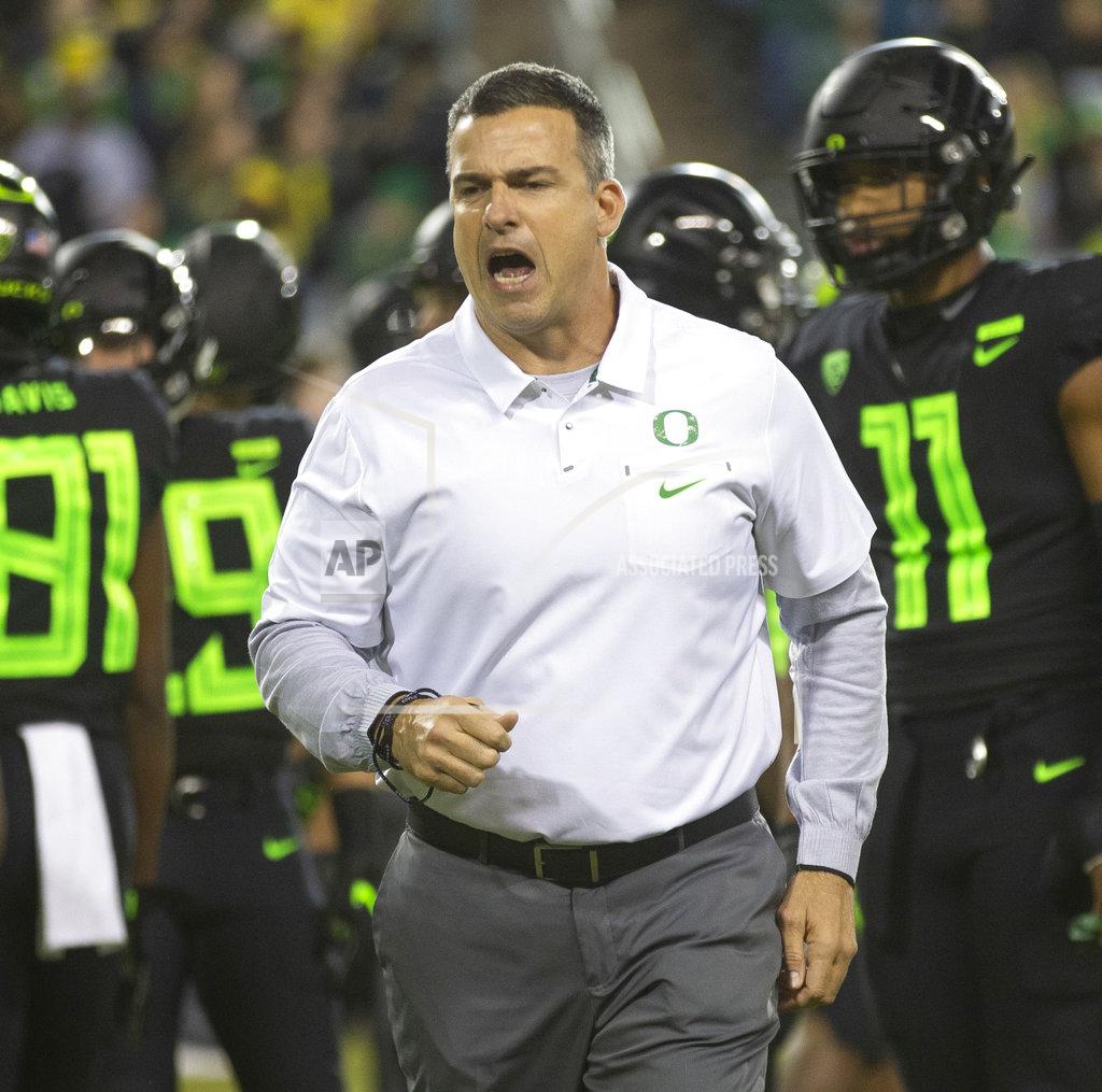 Oregon head football coach Mario Cristobal leads his team through warmups before their NCAA college football game against Arizona State Saturday, Nov. 17, 2018, in Eugene, Ore. (AP Photo/Chris Pietsch)