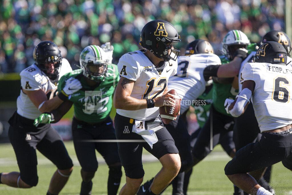 Sholten Singer Appalachian State quarterback Zac Thomas (12) drops back to pass as they take on Marshall during an NCAA college football game Saturday, Sept. 19, 2020, in Huntington, W.Va. (Sholten Singer/The Herald-Dispatch via AP)