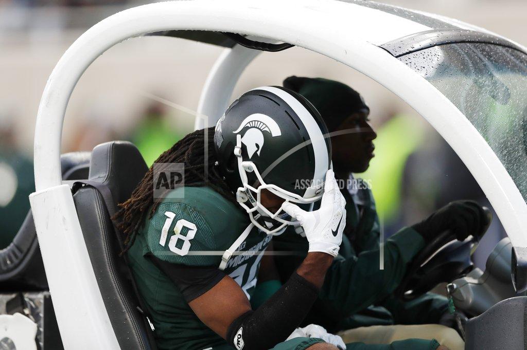 Carlos Osorio CORRECTS TO FELTON DAVIS III, NOT KALON GERVIN - Michigan State wide receiver Felton Davis III is carted off the field during the first half of an NCAA college football game against Michigan, Saturday, Oct. 20, 2018, in East Lansing, Mich. (AP Photo/Carlos Osorio)