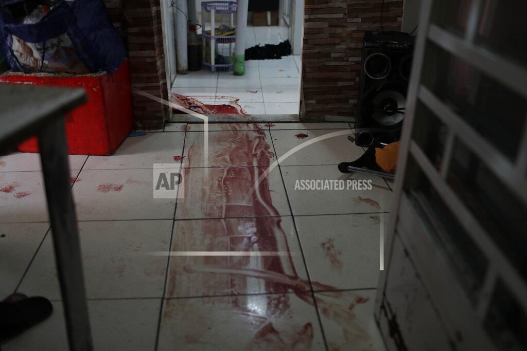 Silvia Izquierdo Blood covers the floor of a home during a police operation targeting drug traffickers in the Jacarezinho favela of Rio de Janeiro, Brazil, Thursday, May 6, 2021. At least 25 people died including one police officer and 24 suspects, according to the press office of Rio's civil police. (AP Photo/Silvia Izquierdo)