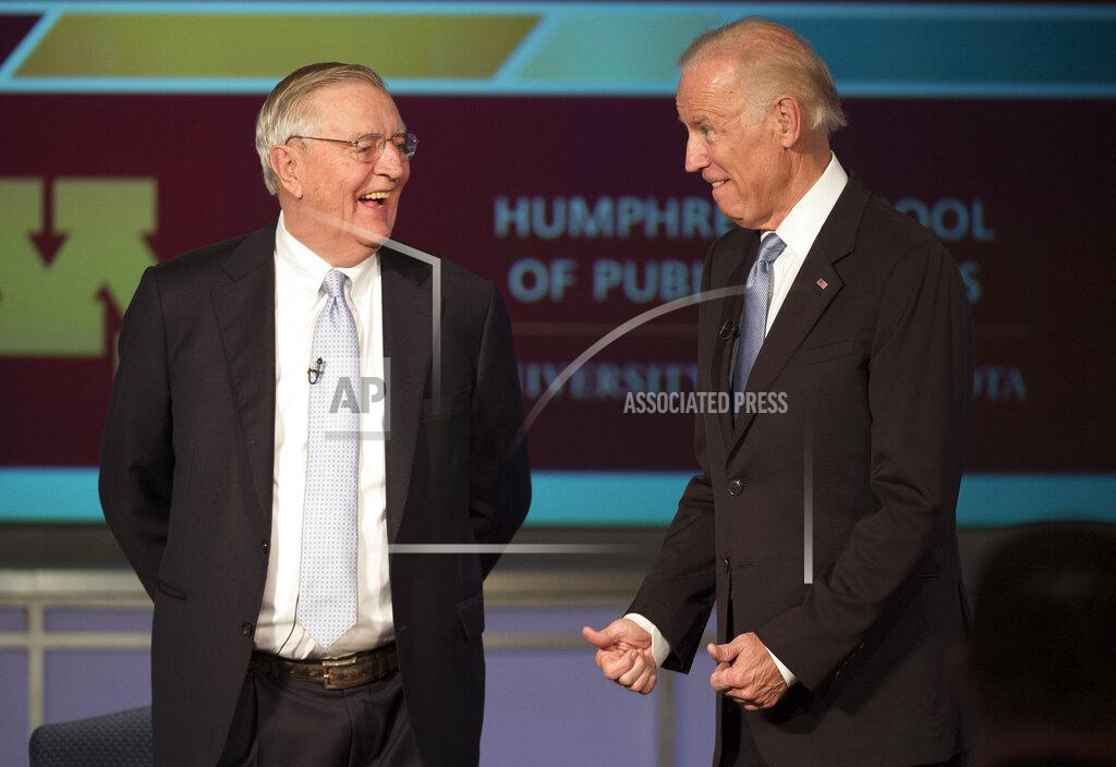 Molly Riley FILE - In this Tuesday, Oct. 20, 2015, file photo, Vice President Joe Biden talks with former Vice President Walter Mondale as they participate in a forum honoring Mondale's legacy, at George Washington University in Washington. Mondale, a liberal icon who lost the most lopsided presidential election after bluntly telling voters to expect a tax increase if he won, died Monday, April 19, 2021. He was 93. (AP Photo/Molly Riley, File)