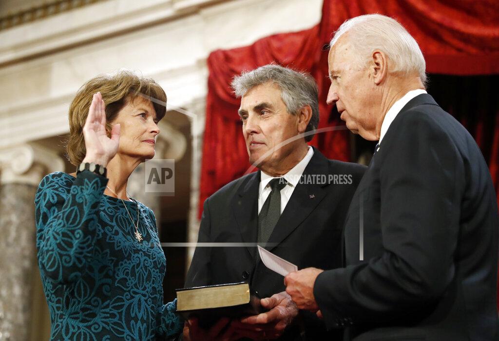 Alex Brandon FILE - In this Jan. 3, 2017, file photo, Vice President Joe Biden, right, after administers the Senate oath of office to Sen. Lisa Murkowski, R-Alaska, as her husband Verne Martell holds a Bible, during a mock swearing in ceremony in the Old Senate Chamber on Capitol Hill in Washington as the 115th Congress begins. The oath, which normally doesn’t attract much attention, has become a common subject in the final days of the Trump presidency, being invoked by members of both parties as they met Wednesday, Jan. 6, 2021 to affirm Biden's win and a pro-Trump mob stormed the U.S. Capitol. Murkowski vowed to honor the oath she took and affirm the results of the presidential election while urging colleagues to do the same. (AP Photo/Alex Brandon, File)