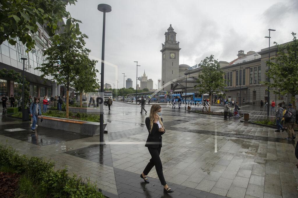 Pavel Golovkin FILE - In this Thursday, July 10, 2021 file photo, a woman wearing a face walks in a street in Moscow, Russia. Moscow’s mayor on Saturday, June 12 ordered a week off for some workplaces and imposed restrictions on many businesses to fight coronavirus infections that have more than doubled in the past week. (AP Photo/Pavel Golovkin, file)
