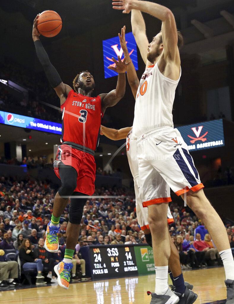 Andrew Shurtleff Stony Brook guard Elijah Olaniyi (3) shoots next to Virginia forward Jay Huff (30) during an NCAA college basketball game in Charlottesville, Va., Wednesday, Dec. 18, 2019. (AP Photo/Andrew Shurtleff)