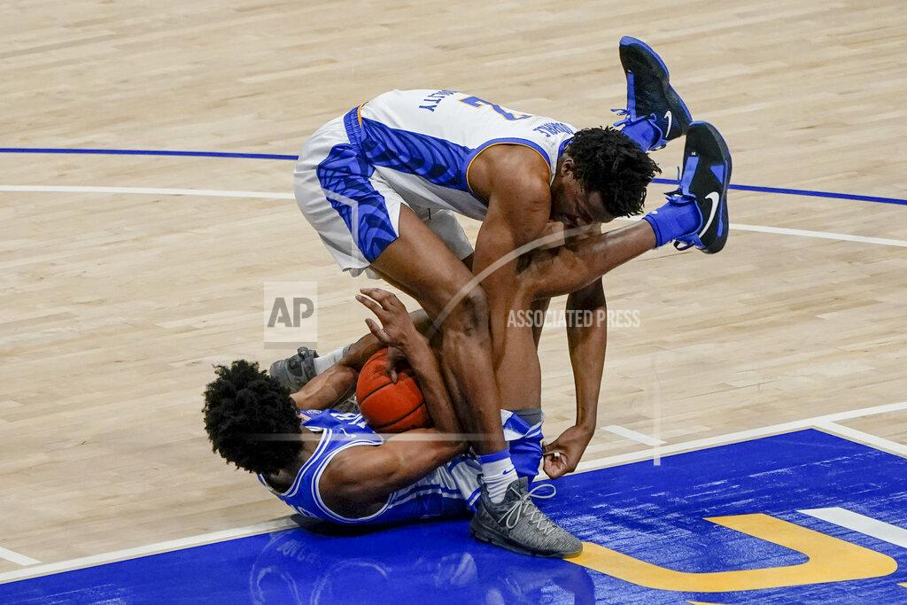 Keith Srakocic Pittsburgh's Femi Odukale (2) and Duke's Jeremy Roach scramble for a loose ball during the second half of an NCAA college basketball game Tuesday, Jan. 19, 2021, in Pittsburgh. (AP Photo/Keith Srakocic)