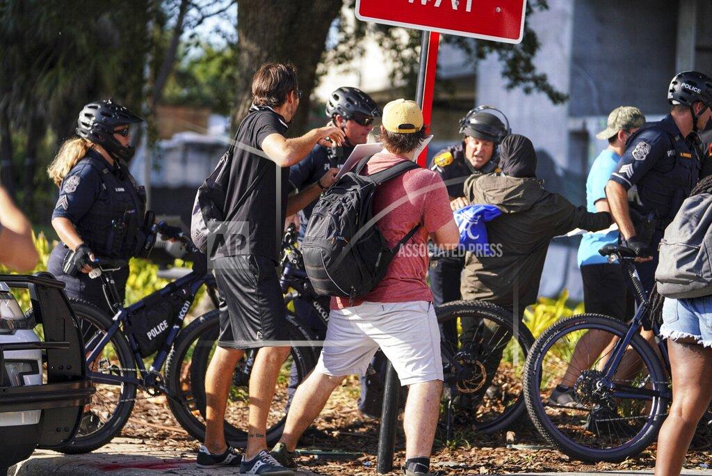 Martha Asencio Rhine Tampa police officers push back on people who tried to get past the line to access an Interstate 275 on-ramp Sunday, May 31, 2020 in Tampa, Fla, during protests over the death of George Floyd, who died May 25 after he was pinned at the neck by a Minneapolis police officer. (Martha Asencio Rhine/Tampa Bay Times via AP)