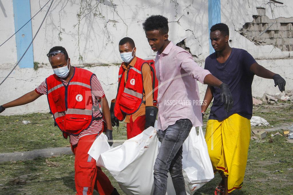 Farah Abdi Warsameh Rescue workers carry away the body of a civilian who was killed in a blast in Mogadishu, Somalia Thursday, Nov. 25, 2021. Witnesses say a large explosion has occurred in a busy part of Somalia's capital during the morning rush hour. (AP Photo/Farah Abdi Warsameh)