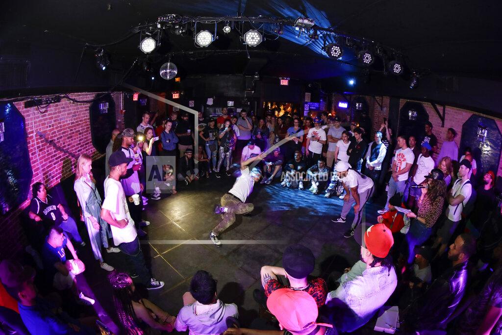 People watch breakers during a competition hosted by Supreme Beingz at the Mercury Lounge Friday, June 7, 2019, in New York. Many in the breaking community are eager for the art form to expand its audience after the International Olympic Committee announced that it would become an official sport at the Paris 2024 games. But that optimism is hardly unanimous. (AP Photo/Frank Franklin II)