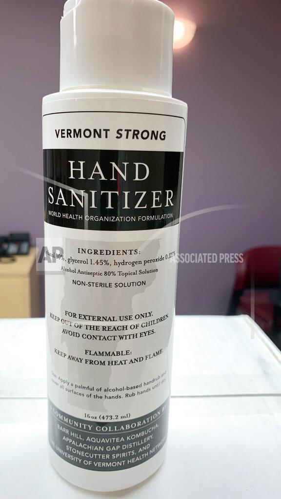 This 16-ounce bottle of Vermont Strong hand sanitizer, shown on April 29, 2020 at the UVM Medical Center in Burlington, Vt., is part of the supply being made through a collaboration of local distilleries and a kombucha maker for the University of Vermont Health Network. The hospital had extra hand sanitizer but needed face shields, so it swapped with another hospital on one of several new online matchmaking platforms that enable hospitals to swap supplies or get donations of them to quickly fill supply gaps. (Charles Miceli/University of Vermont Medical Center via AP)