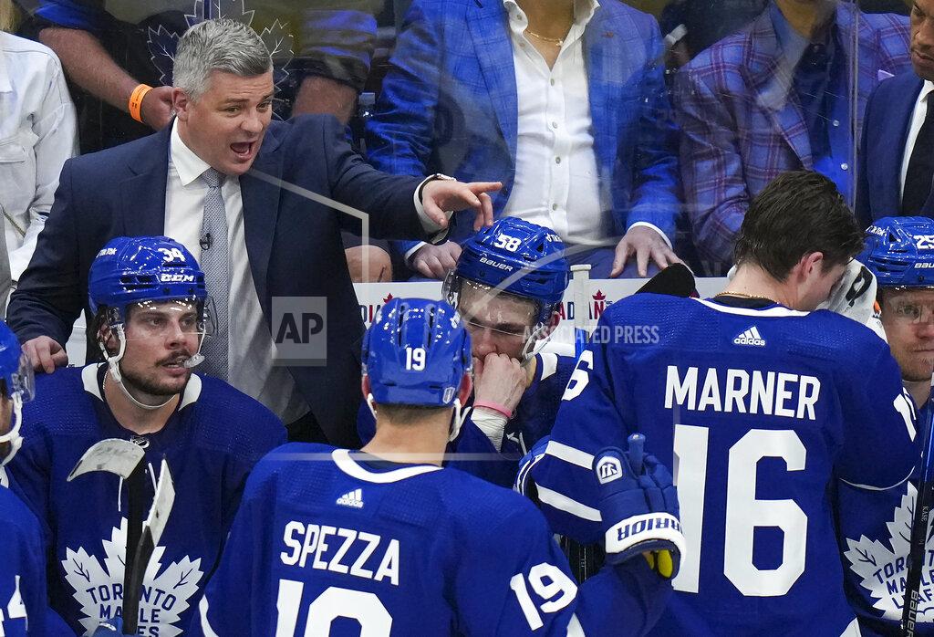 Nathan Denette Toronto Maple Leafs head coach Sheldon Keefe, top left, calls a timeout while playing against the Tampa Bay Lightning during the third period of Game 7 in an NHL hockey first-round playoff series in Toronto, Saturday, May 14, 2022. (Nathan Denette/The Canadian Press via AP)