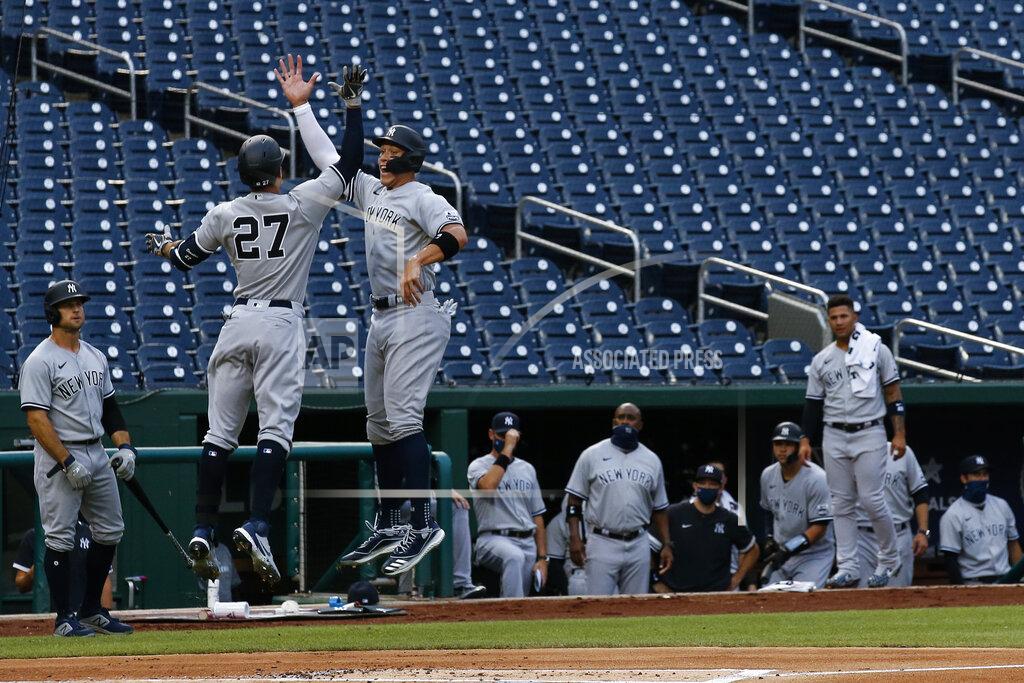 Alex Brandon New York Yankees' Giancarlo Stanton (27) jumps to celebrate his two-run homer with Aaron Judge during the first inning of an opening day baseball game against the Washington Nationals at Nationals Park, Thursday, July 23, 2020, in Washington. (AP Photo/Alex Brandon)