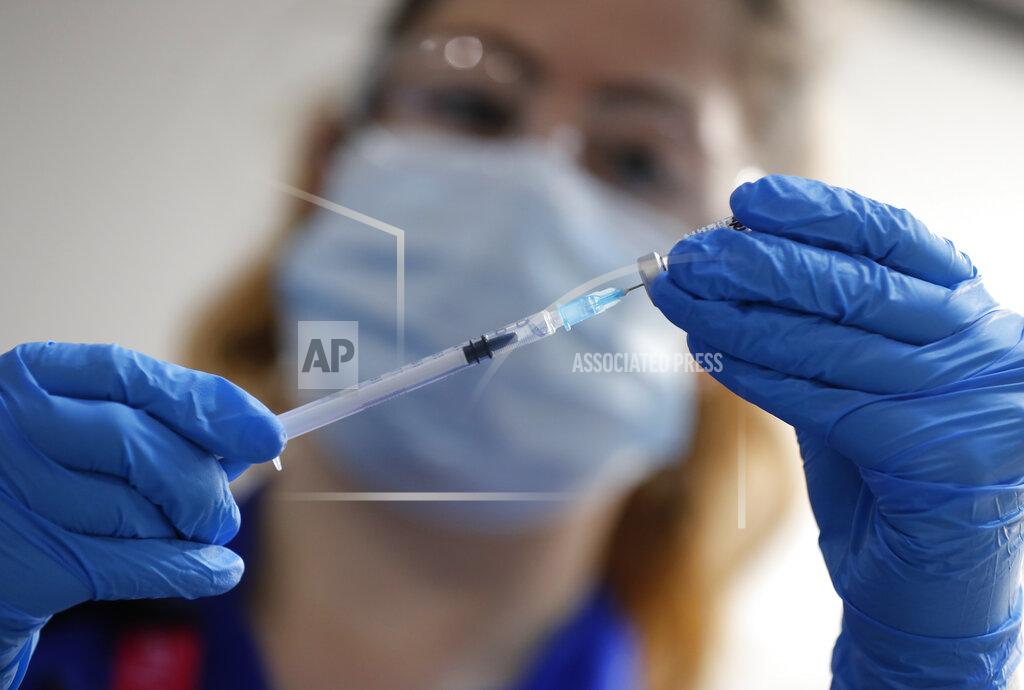 A nurse prepares a shot of the Pfizer-BioNTech COVID-19 vaccine at Guy's Hospital in London, Tuesday, Dec. 8, 2020, as the U.K. health authorities rolled out a national mass vaccination program. U.K. regulators said Wednesday Dec. 9, 2020, that people who have a “significant history’’ of allergic reactions shouldn’t receive the new Pfizer/BioNTech vaccine while they investigate two adverse reactions that occurred on the first day of the country’s mass vaccination program. (AP Photo/Frank Augstein, Pool)