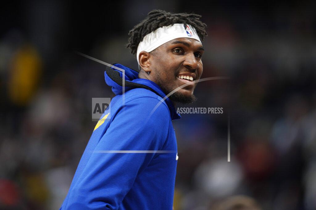 David Zalubowski FILE - Golden State Warriors center Kevon Looney (5) smiles during the first half of an NBA basketball game Thursday, March 10, 2022, in Denver. The NBA's free agency period opens Thursday night, June 30, 2022, with teams and players finally free to negotiate new deals. (AP Photo/David Zalubowski, File)