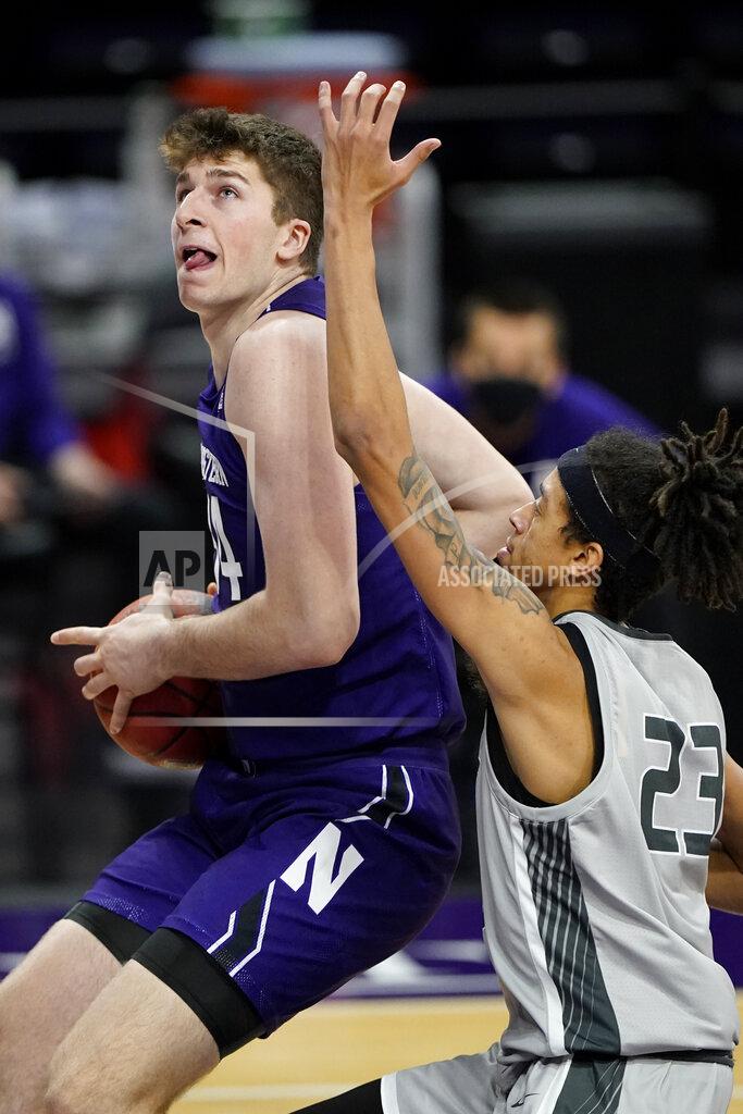 Nam Y. Huh Northwestern center Matthew Nicholson, left, drives to the basket against Chicago State forward Jordan Polynice during the second half of an NCAA college basketball game in Evanston, Ill., Saturday, Dec. 5, 2020. (AP Photo/Nam Y. Huh)
