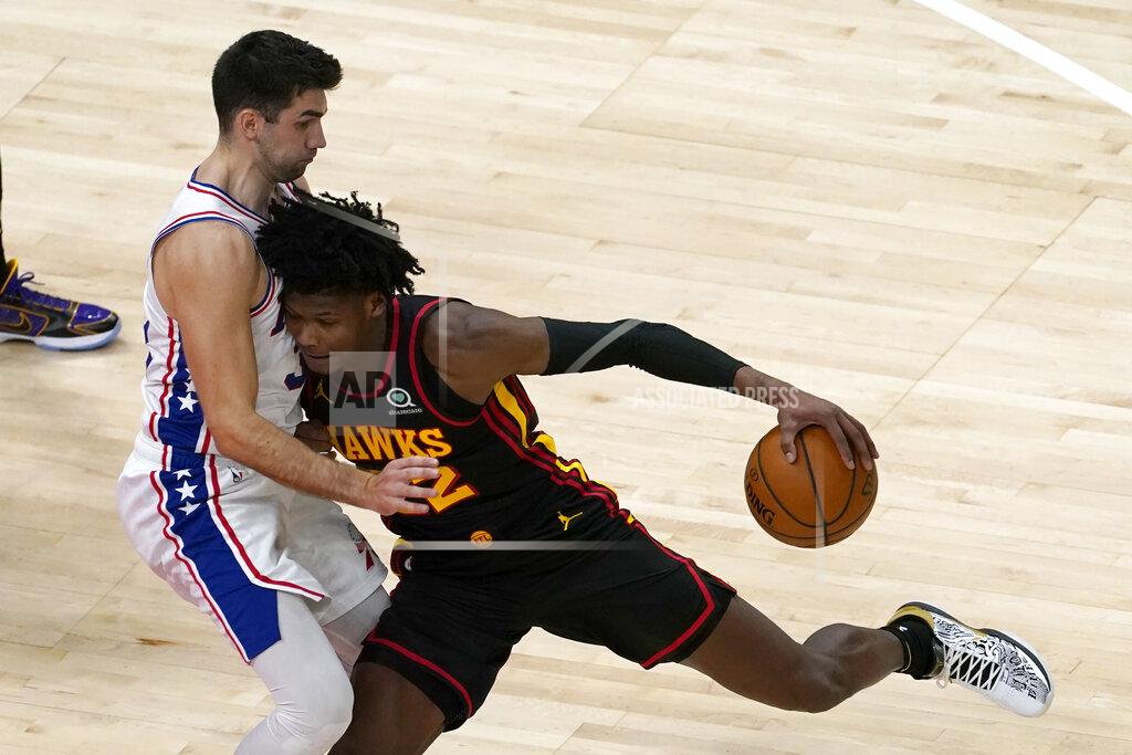 John Bazemore Atlanta Hawks forward De'Andre Hunter (12) drives against Philadelphia 76ers guard Dakota Mathias (33) during the first half of an NBA basketball game Monday, Jan. 11, 2021, in Atlanta. (AP Photo/John Bazemore)