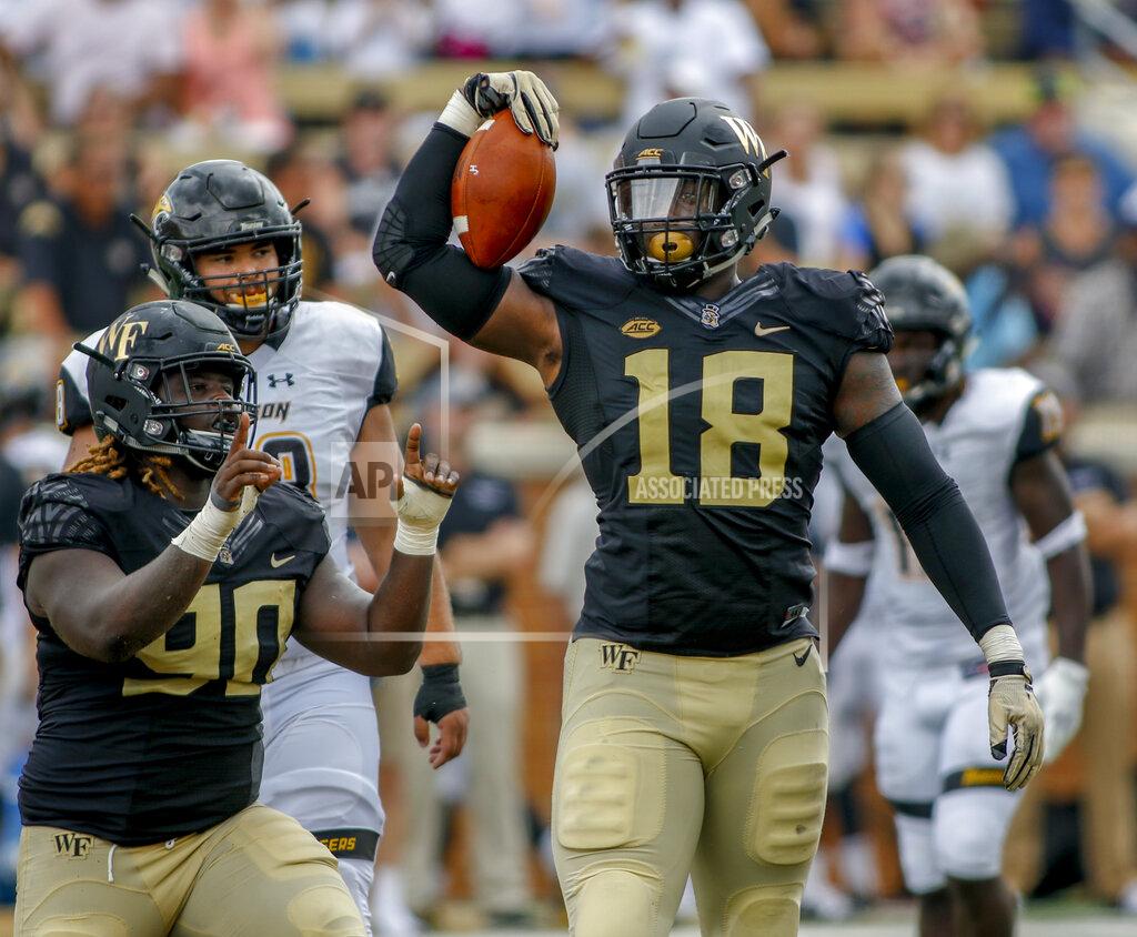 Nell Redmond FILE - In this Sept. 9, 2018, file photo, Wake Forest defensive linemen Carlos Basham Jr. (18) and Sulaiman Kamara celebrate after sacking Towson quarterback Tom Flacco in the first half of an NCAA college football game, in Winston-Salem, N.C. Basham was selected to The Associated Press All-Atlantic Coast Conference football team, Tuesday, Dec. 10, 2019. (AP Photo/Nell Redmond, File)