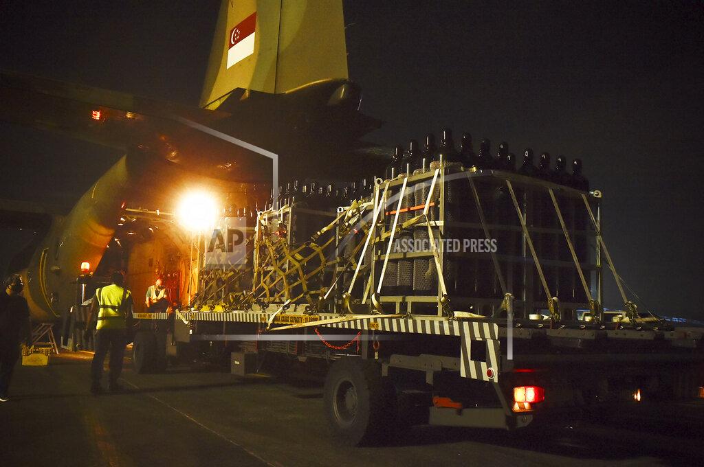 Uncredited In this photo released by the Ministry of Foreign Affairs Singapore, palettes oxygen cylinders are being loaded into the Republic of Singapore Air Force C-130 aircraft as part of humanitarian assistance to India at the Paya Lebar Air Base in Singapore, Wednesday, April 28, 2021. (Ministry of Foreign Affairs Singapore via AP)