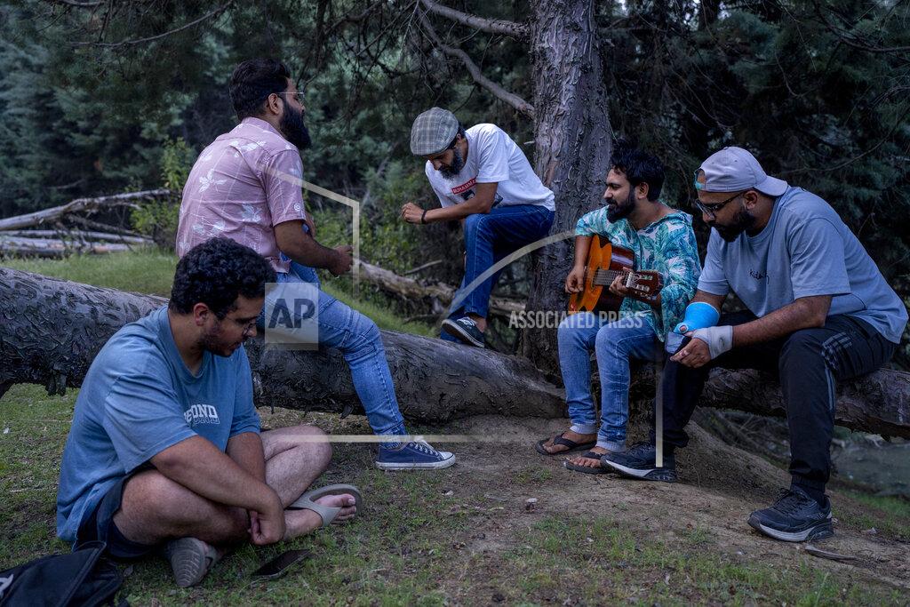Dar Yasin Kashmiri Musician and singer jam on a secluded place on the outskirts of Srinagar, Indian controlled, June 14, 2022. Musicians and artists in Kashmir are ordinary in life, each clutching onto the lived experiences of growing up in one of the world's most militarized zones that has known little but conflict for decades. But together, they embody a new form of music, a blend of progressive rock and hip hop that is an assertive expression of the region's political and cultural aspirations. (AP Photo/Dar Yasin)