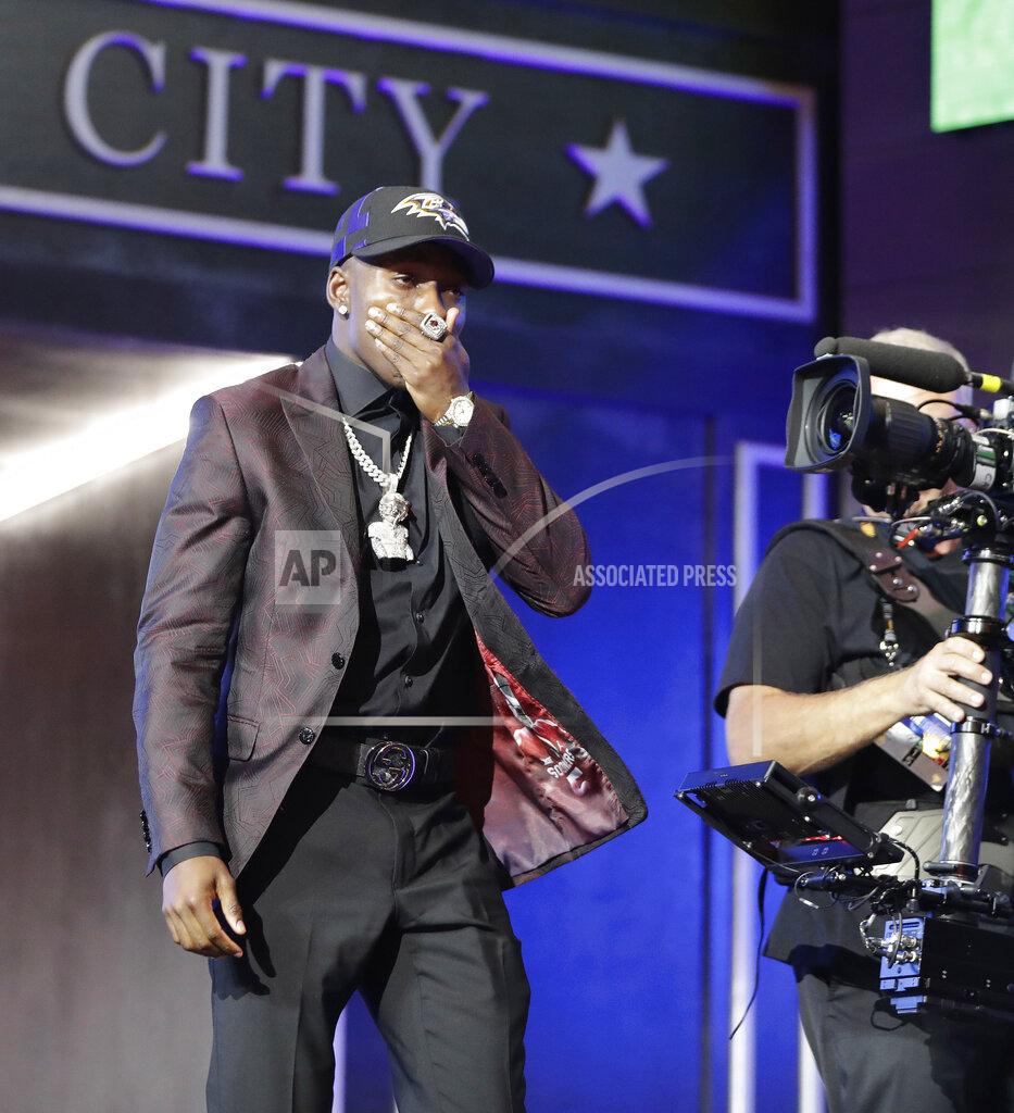 Mark Humphrey Oklahoma wide receiver Marquise Brown walks on stage after the Baltimore Ravens selected him in the first round at the NFL football draft, Thursday, April 25, 2019, in Nashville, Tenn. (AP Photo/Mark Humphrey)