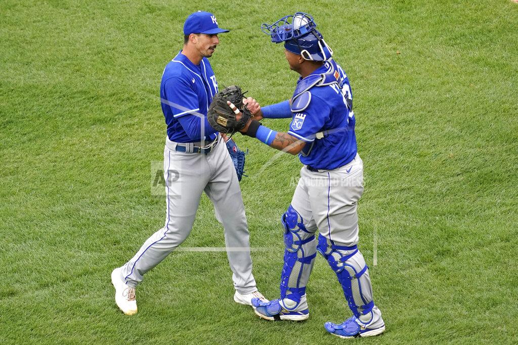 Nam Y. Huh Kansas City Royals relief pitcher Kyle Zimmer, left, celebrates with catcher Salvador Perez after the Kansas City Royals defeated the Chicago White Sox in a baseball game in Chicago, Sunday, April 11, 2021. (AP Photo/Nam Y. Huh)