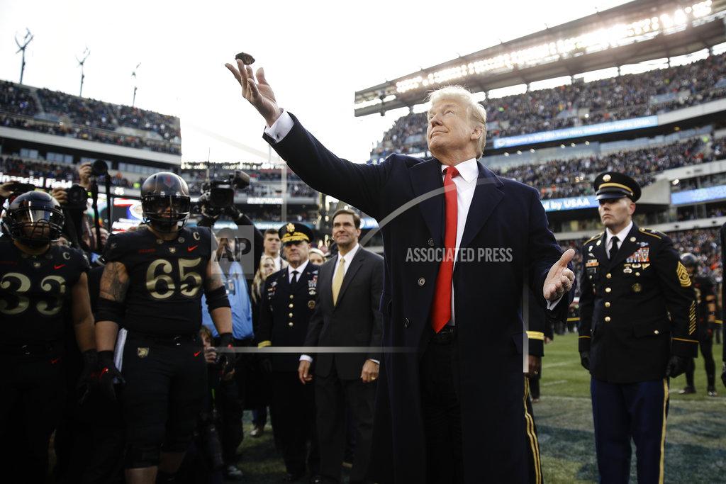 Matt Rourke President Donald Trump tosses the coin before the Army-Navy NCAA college football Saturday, Dec. 8, 2018, in Philadelphia. (AP Photo/Matt Rourke)