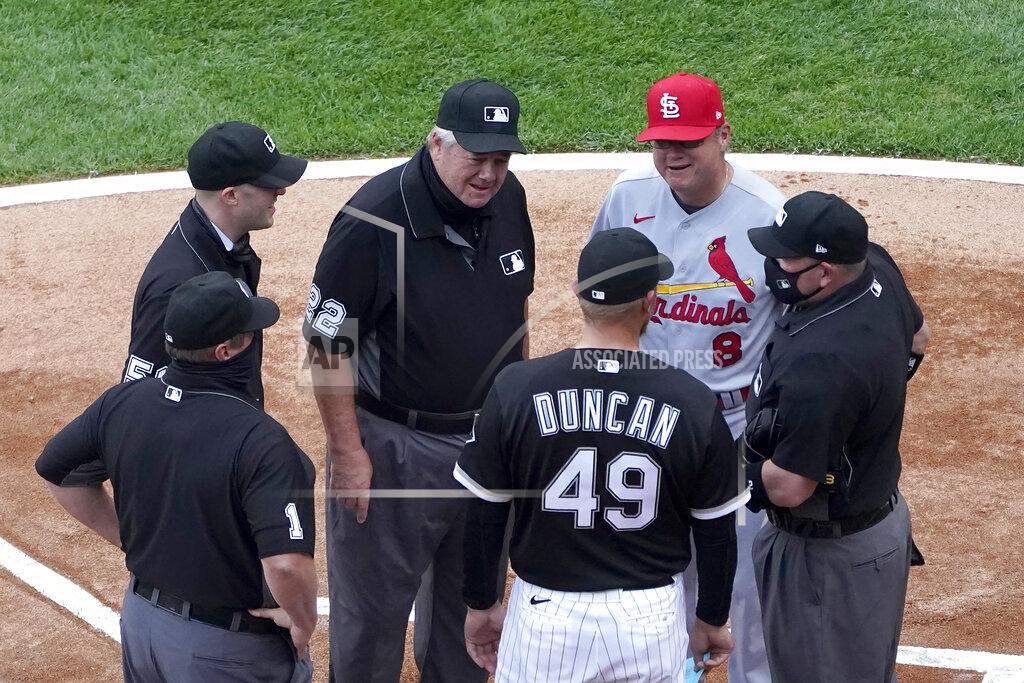 Charles Rex Arbogast Umpire Joe West (22) talks with Chicago White Sox analytics coordinator Shelley Duncan (49) and St. Louis Cardinals manager Mike Shildt (8) as West's crew of Bruce Dreckman (1) Nic Lentz (59) and Dan Bellino listen before an interleague baseball game Monday, May 24, 2021, in Chicago. West now ties the major league record for games umpired. (AP Photo/Charles Rex Arbogast)