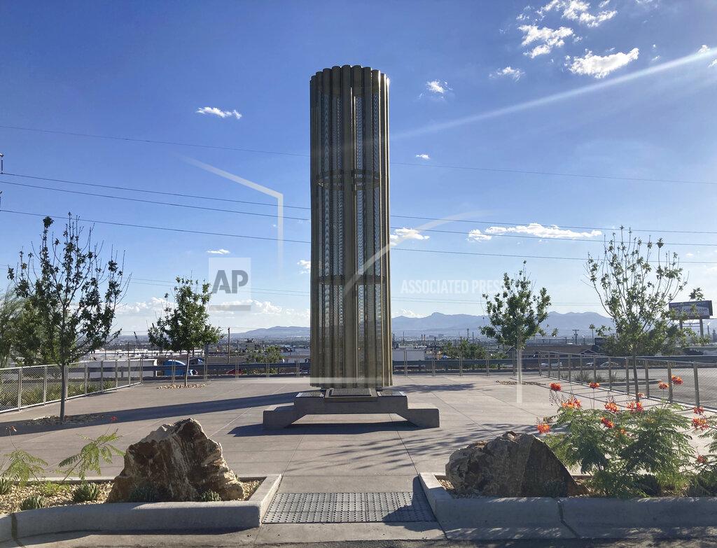 Morgan Lee A towering memorial in the form of a giant candle to the victims of a mass shooting in El Paso, Texas, casts a shadow on Thursday, Aug. 26, 2021. The August 2019 massacre of 23 people at the adjacent Walmart store prompted many people to buy guns for personal protection. A new "constitutional carry" law in Texas allows most gun owners age 21 and older to carry a holstered handgun — concealed or not — in public without getting a license and related training. (AP Photo/Morgan Lee)