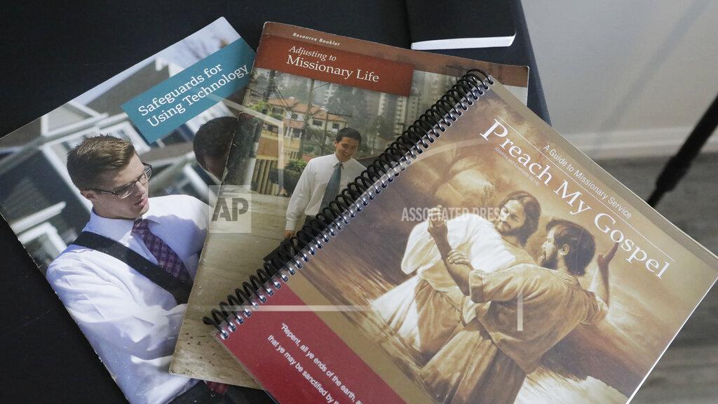 Rick Bowmer In this May 27, 2020, photo, several guides for missionary service sit on a desk at the apartment of missionaries with The Church of Jesus Christ of Latter-day Saints in Brigham City, Utah. After hastily bringing home 26,000 young men and women who were serving in foreign countries, the faith has begun sending many of them out again in their home countries with a new focus on online work that could stick even when the pandemic is over, church officials told The Associated Press. (AP Photo/Rick Bowmer)
