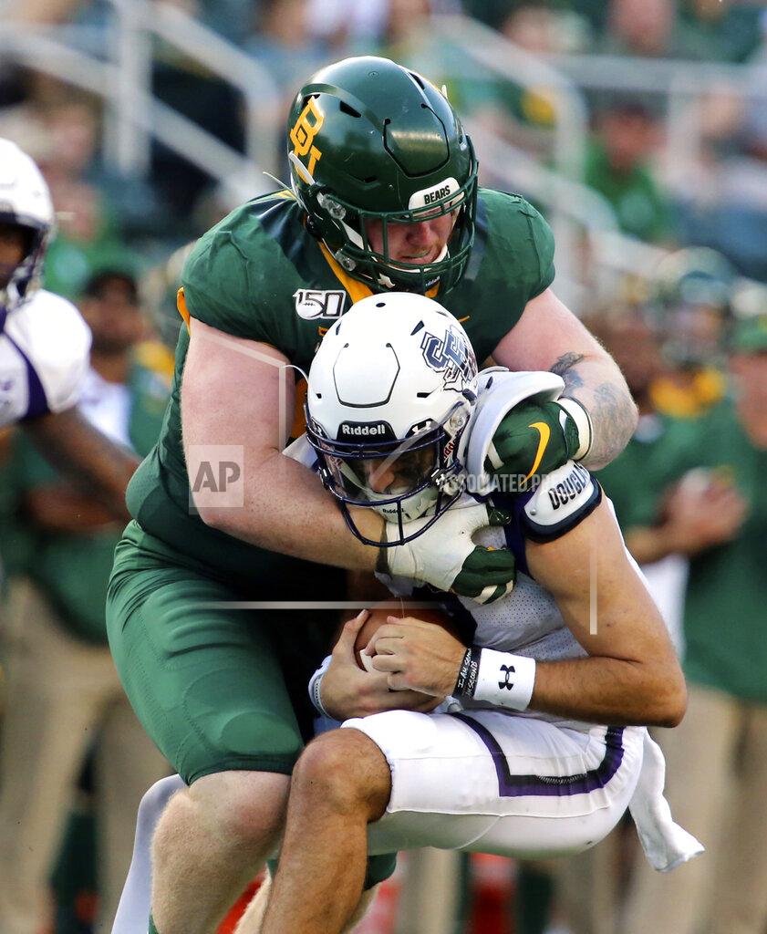 Rod Aydelotte Baylor defensive tackle James Lynch, top, sacks Stephen F. Austin's Trae Self, bottom, in the first half of an NCAA college football game Saturday, Aug. 31, 2019, in Waco, Texas. (Rod Aydelotte/Waco Tribune-Herald via AP)