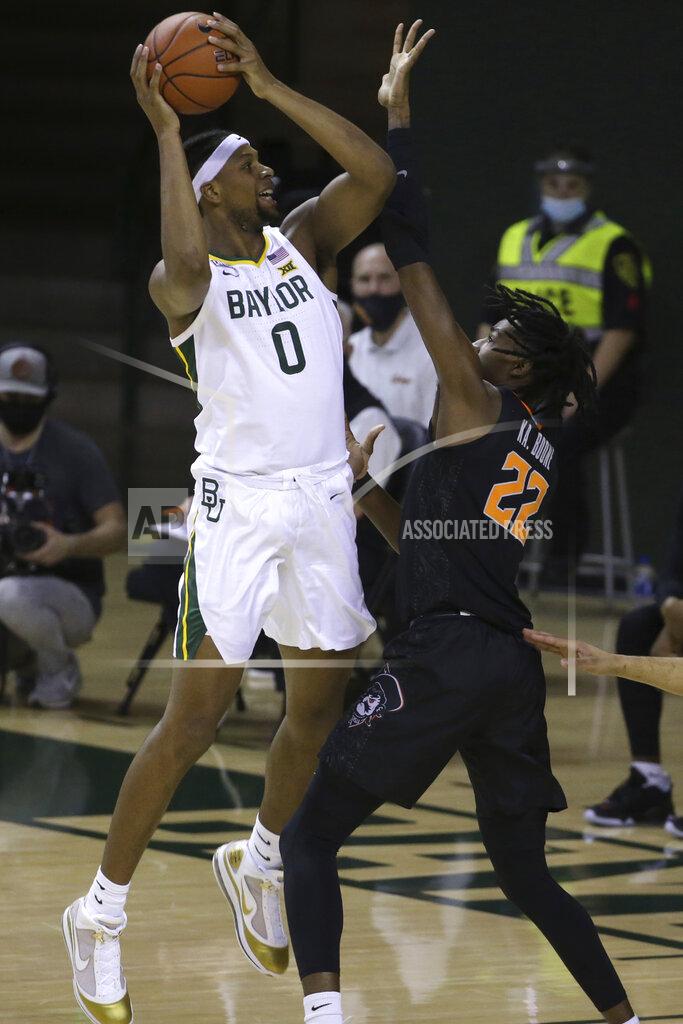 Jerry Larson Baylor forward Flo Thamba (0) attempts a shot against Oklahoma State forward Kalib Boone (22) in the first half of an NCAA college basketball game, Thursday, March 4, 2021, in Waco, Texas. (AP Photo/Jerry Larson)