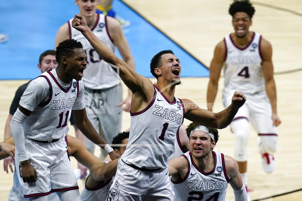 Michael Conroy FILE - In this April 3, 2021, file photo, Gonzaga guard Jalen Suggs (1) celebrates making the game-winning basket against UCLA during overtime in a men's Final Four NCAA college basketball tournament semifinal in Indianapolis. Gonzaga carried a No. 1 ranking all last season before falling a win short of becoming college basketball’s first unbeaten national champion in 45 years. The Zags were the runaway top choice in The Associated Press Top 25 men’s college basketball preseason poll released Monday, Oct. 18, 2021, file photo. (AP Photo/Michael Conroy, File)