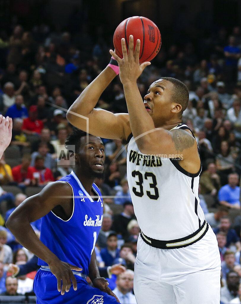 Stephen B. Morton Wofford's Cameron Jackson (33) goes up for a shot past Seton Hall's Michael Nzei, left, during the first half of a first-round game in the NCAA men’s college basketball tournament in Jacksonville, Fla., Thursday, March 21, 2019. (AP Photo/Stephen B. Morton)