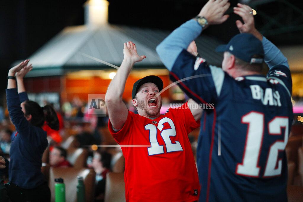 Darin Smith, right, and Derrick Chapman celebrate while watching Super Bowl 53 between the New England Patriots and the Los Angeles Rams at the Westgate Superbook sports book, Sunday, Feb. 3, 2019, in Las Vegas. (AP Photo/John Locher)
