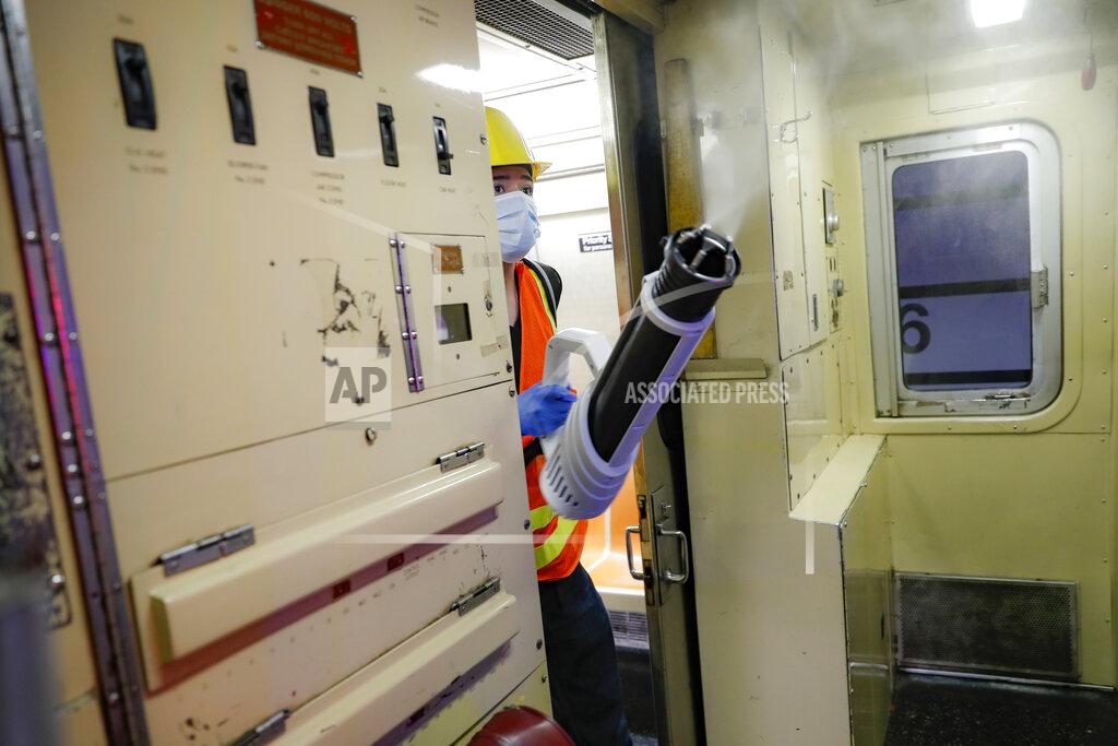 John Minchillo A contractor cleans a subway car at the 96th Street station to control the spread of COVID-19, Thursday, July 2, 2020, in New York. Mass transit systems around the world have taken unprecedented — and expensive — steps to curb the spread of the coronavirus, including shutting down New York subways overnight and testing powerful ultraviolet lamps to disinfect seats, poles and floors. (AP Photo/John Minchillo)
